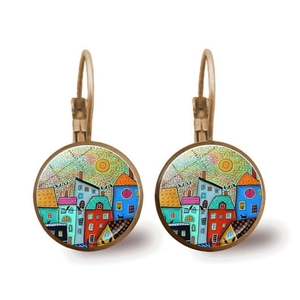 Macro detail of round abstract art earrings featuring colorful house painting and bronze hooks