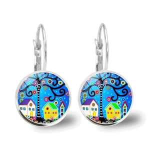 Macro detail of leverback earrings featuring colorful hand-painted house and tree patterns