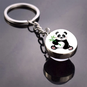 Cute cartoon panda holding green bamboo round metal keychain with polished mirror reflection