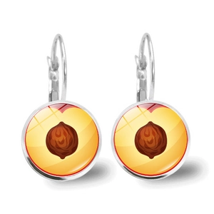 Close-up of silver drop earrings featuring realistic peach fruit slice glass dome design
