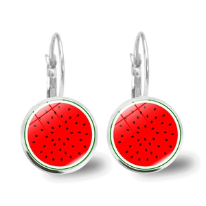 Close-up of handmade round glass drop earrings featuring realistic red watermelon slice patterns