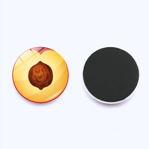 Detailed view of peach slice crystal glass fridge magnet with magnetic black backing