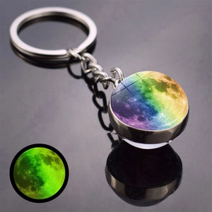 Glow-in-the-dark moon keychain detail showing luminous green effect and silver metal ring