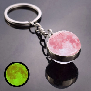 Luminous moon keychain with silver metal ring and pink moon design in glass dome