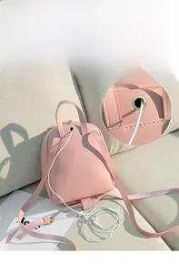 Pink PU leather mini backpack detail showing the metal earphone port and gold zipper