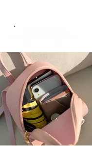 Pink mini backpack interior showing large capacity for phone, umbrella and cosmetics
