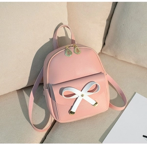 Detail of pink PU leather mini backpack with bow and gold leaf-shaped zipper pulls