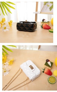 Macro view of black and white mini jelly bags with gold chain straps and metal locks