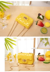 Macro detail of yellow quilted jelly mini bag with gold twist lock and chain strap