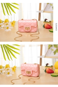 Detail view of pink quilted jelly bag with gold chain strap and elegant hardware