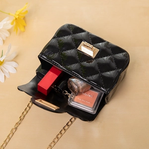 Black quilted jelly crossbody bag with gold chain strap and turn-lock closure