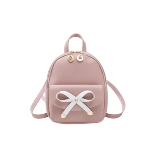 Pink mini backpack for women with white bow detail and golden leaf zipper charms