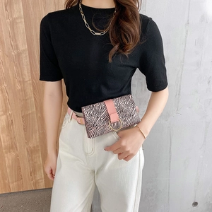 Chic zebra print mini waist bag with pink leather flap and gold ring on model