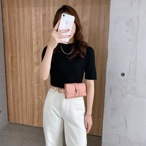 Pink faux leather fanny pack with a gold round buckle and detachable waist belt