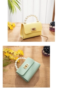 Detail of mini crocodile pattern jelly bags with large pearl handle and gold twist lock