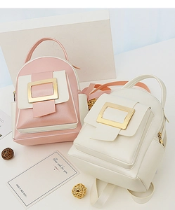 Détail de mini sacs à dos contrastés avec boucles dorées et texture en cuir grainé