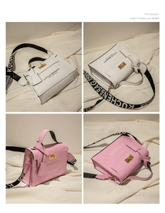 Detailed view of women's patent leather bags with golden twist lock and wide fabric strap