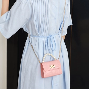 Pink mini crocodile pattern jelly bag with pearl handle and gold chain on model