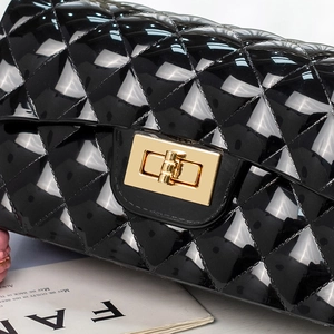 Glossy black quilted jelly bag with elegant golden clasp and pearl chain detail