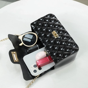 Black quilted jelly bag with pearl chain strap and daily essentials inside for women