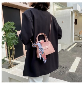 Pink stone pattern mini bag with decorative silk scarf and adjustable strap shown on model