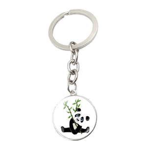 Detail of round silver keychain with cute cartoon panda holding bamboo illustration