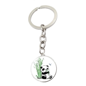 Metal keychain featuring a round cartoon panda eating bamboo with a dragonfly design