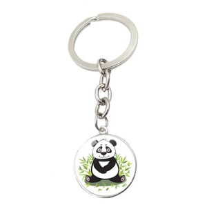 Close-up of a cartoon panda keychain with round metal base and silver link chain