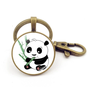 Dettaglio del portachiavi in bronzo con ciondolo in vetro panda e bambù e chiusura a moschettone