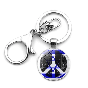 Macro detail of Israel flag keychain featuring Star of David and peace symbol charms