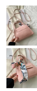 Detailed back and side view of pink crocodile pattern handbag with silk scarf handle detail