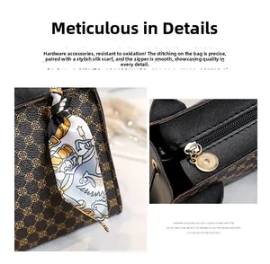 Detail of monogram leather handbag with decorative silk scarf and gold-tone metal zipper