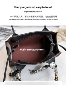 Detail view of the handbag interior with dark red lining and printed silk scarf handle