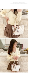 Close-up of white quilted tote bag featuring a decorative colorful patterned silk scarf handle