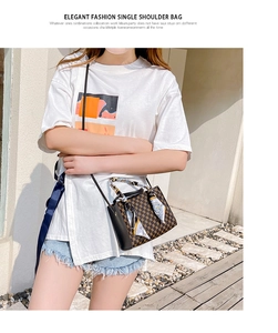Detail of crossbody bag with vintage geometric pattern and silk scarf handle accent