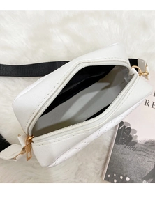 Close-up of white quilted camera bag showing interior grey lining and zipper closure