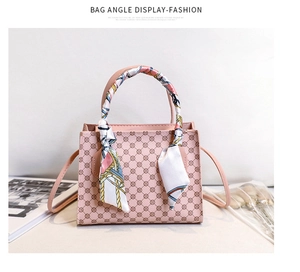 Pink printed tote bag detail with silk scarf handle and retro geometric pattern