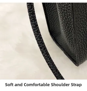 Detail of soft litchi texture leather and comfortable shoulder strap on black bag