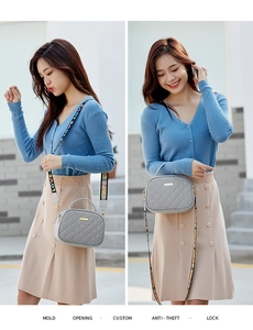 Detailed view of gray quilted crossbody bag with decorative LOVE letter strap and hardware