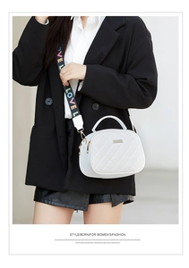 Close-up of white quilted crossbody bag with stylish LOVE letter wide shoulder strap