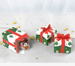 Detailed view of Christmas candy boxes with red 3D bows and festive holiday illustrations