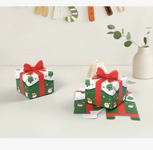 Detailed view of 3D red bow on Christmas candy gift boxes with festive illustrations