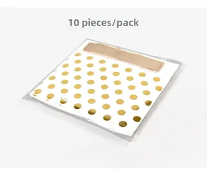 Detail of 10pcs white gift bags with gold foil polka dots and matching satin ribbons