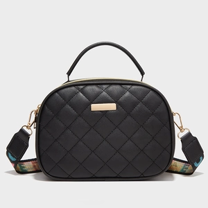 Classic black quilted leather crossbody bag with golden hardware and ethnic strap