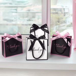 Mini gift bags with elegant bow handles and 'Thank you' text for jewelry packaging