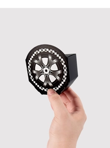 Close-up of black race car party favor box with wheel and checkered flag print