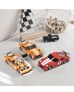 Detail of red and orange race car gift boxes with soft plush bear inside for party decor