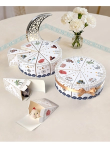Detail of triangular cake-shaped Eid party gift boxes with floral and animal motifs