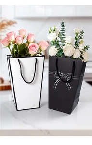 Detail of trapezoid gift bags with silk bow tie for flowers and elegant party favors