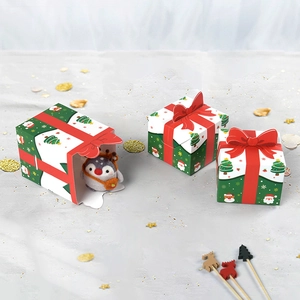 Christmas gift boxes with 3D red bows featuring Santa and reindeer holiday patterns